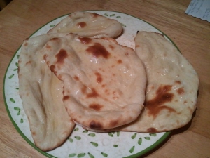 3 pieces of naan, all shiny from the melted ghee
